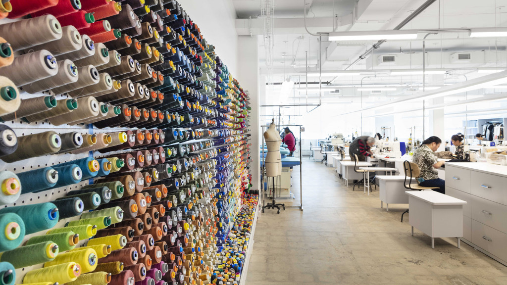 A room with a few people working.